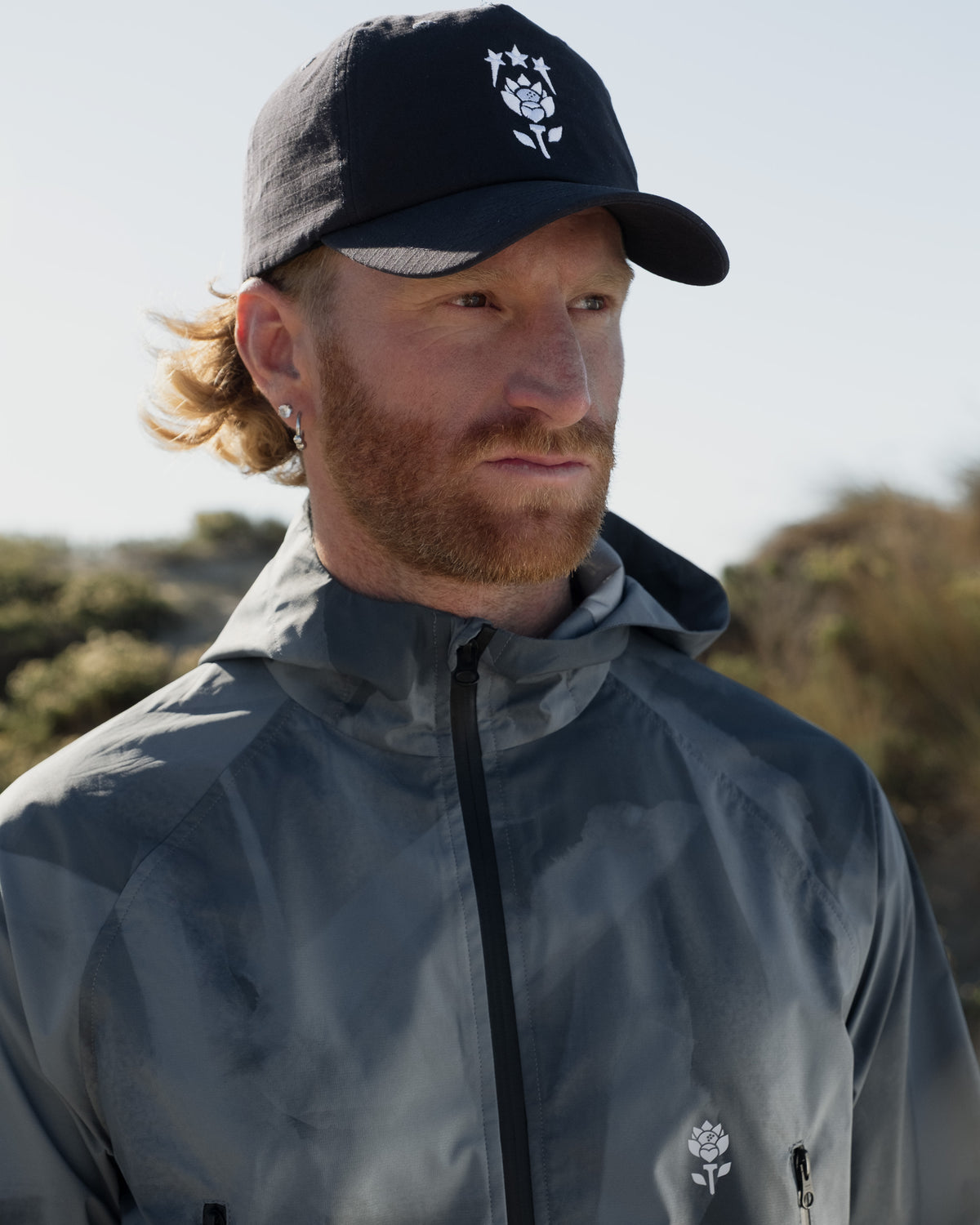 Onda Jacket lifestyle shot — blue jacket styled with Dune Hat by Fiori Golf