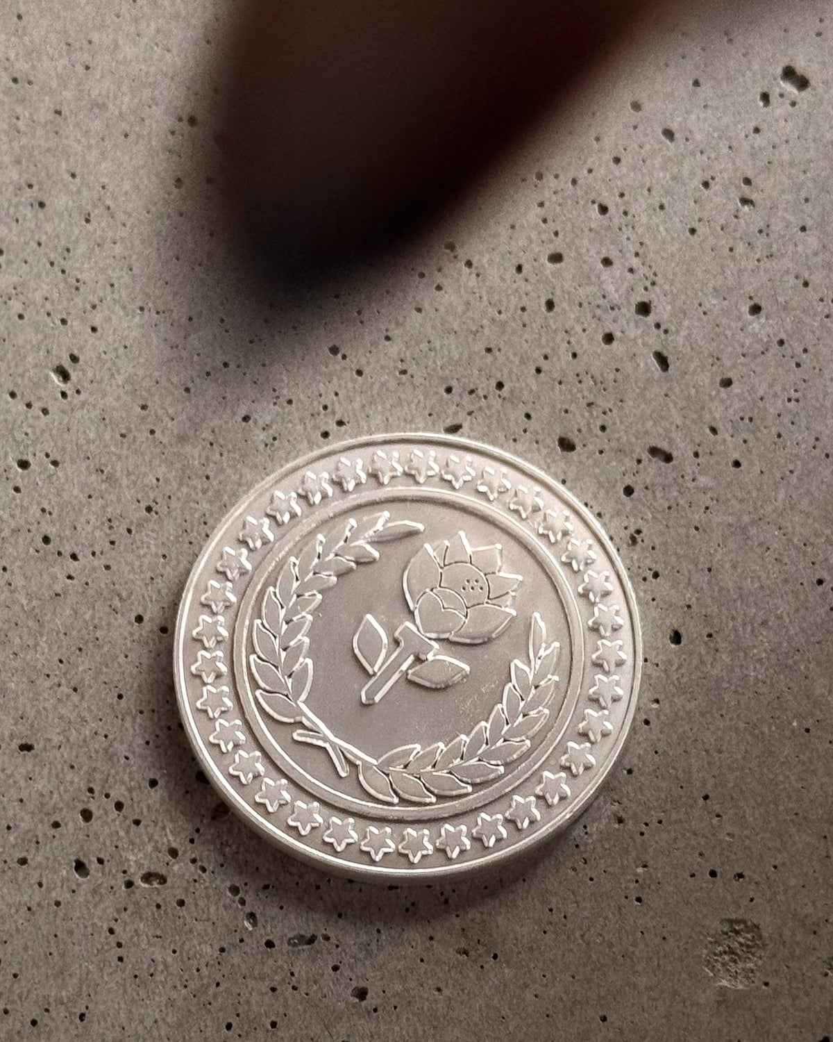 Branded Ball Marker lifestyle shot — matte Fiori logo marker styled by Fiori Golf