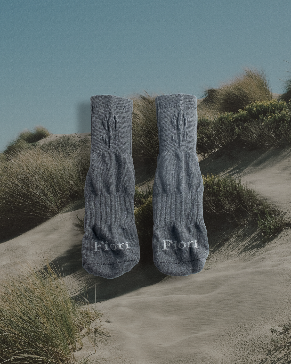 Fiori Embossed Gray Sock close-up — logo detail on heather gray quarter sock